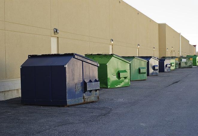 a row of heavy-duty dumpsters ready for use at a construction project in Basehor